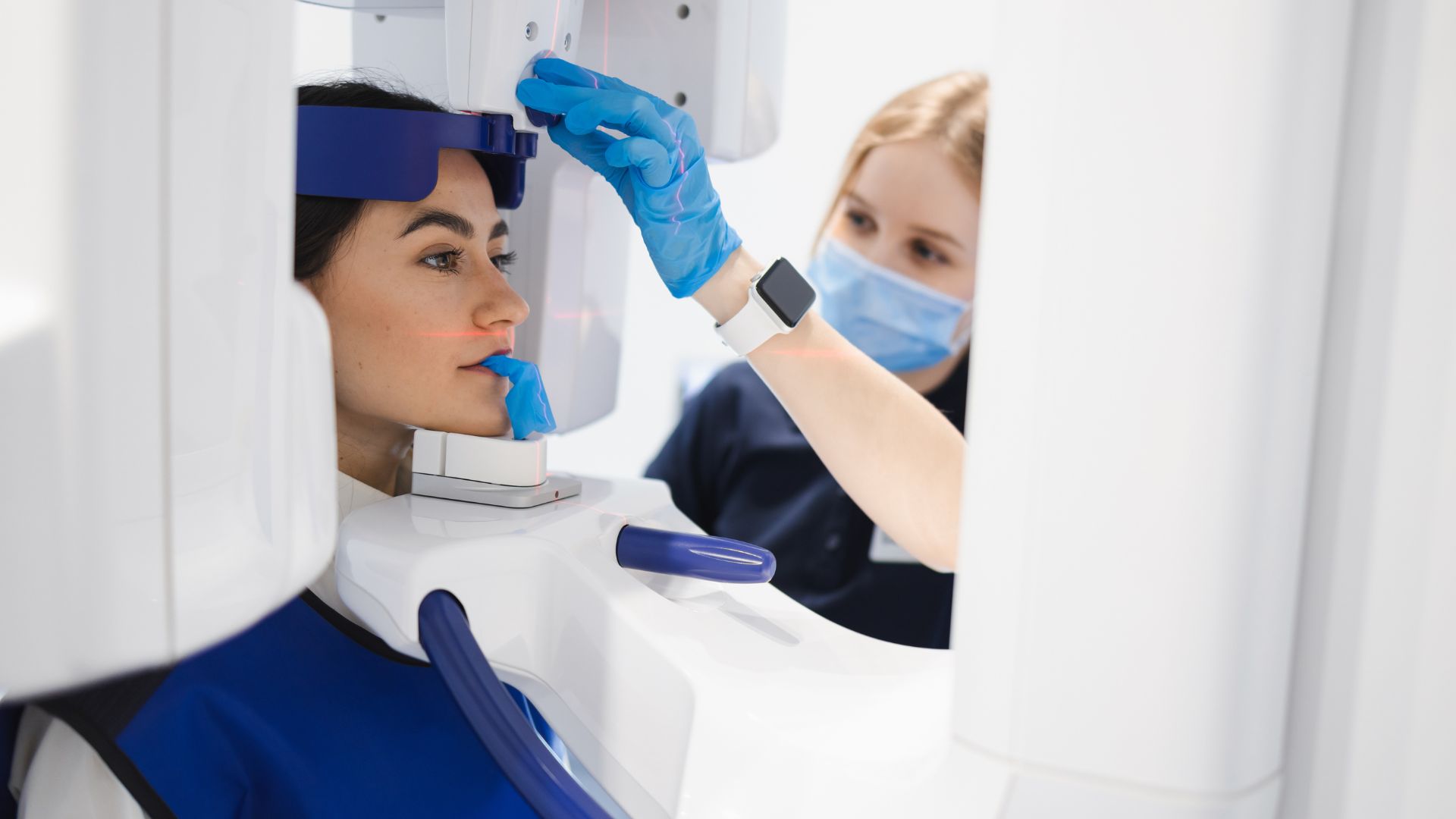 Woman getting an x-ray- dental radiography with Midland Bay Dental.