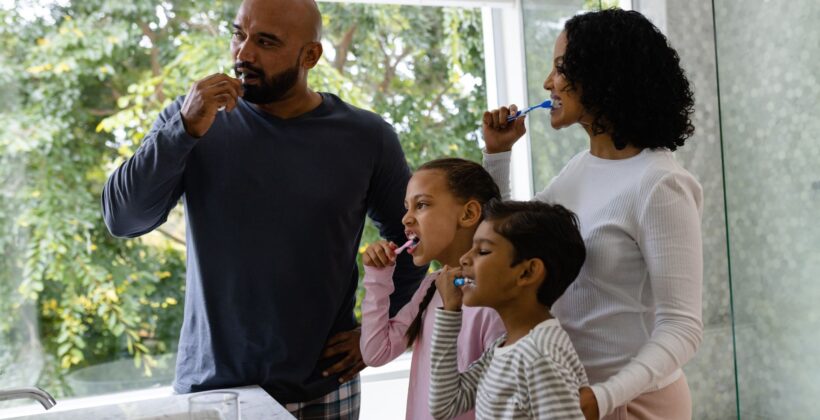 Family brushing their teeth together | Midland Bay Dental.