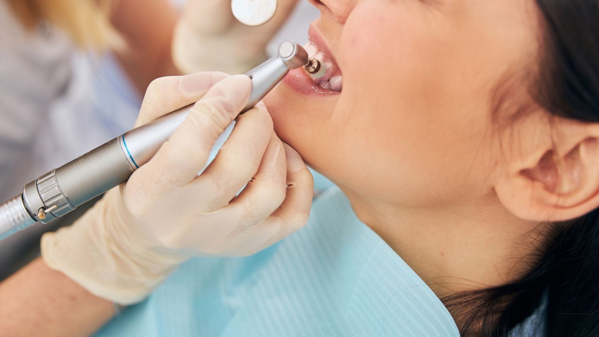 Woman getting dental cleaning - maintaining good oral health with Midland Bay Dental.