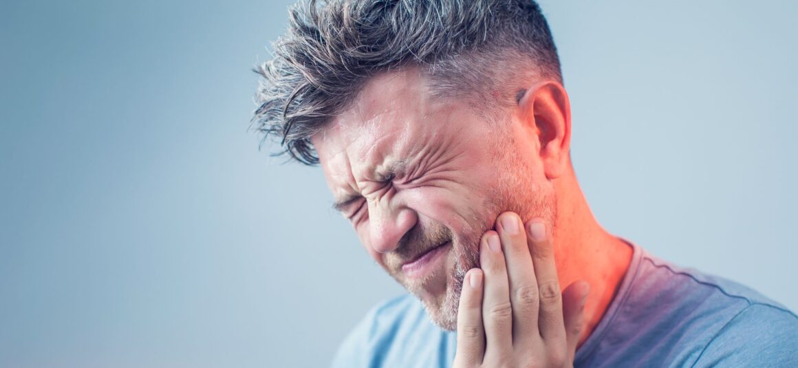 Man with tooth nerve pain - Midland Bay Dental.