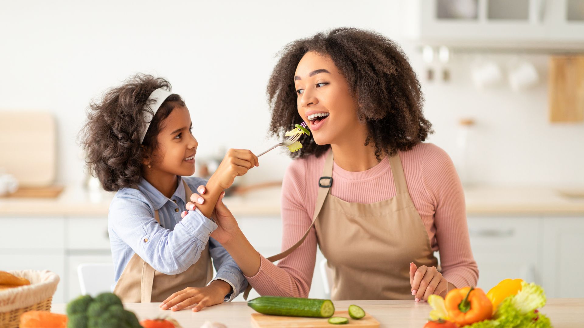 Child snacking with mom - healthy snacks for kids.