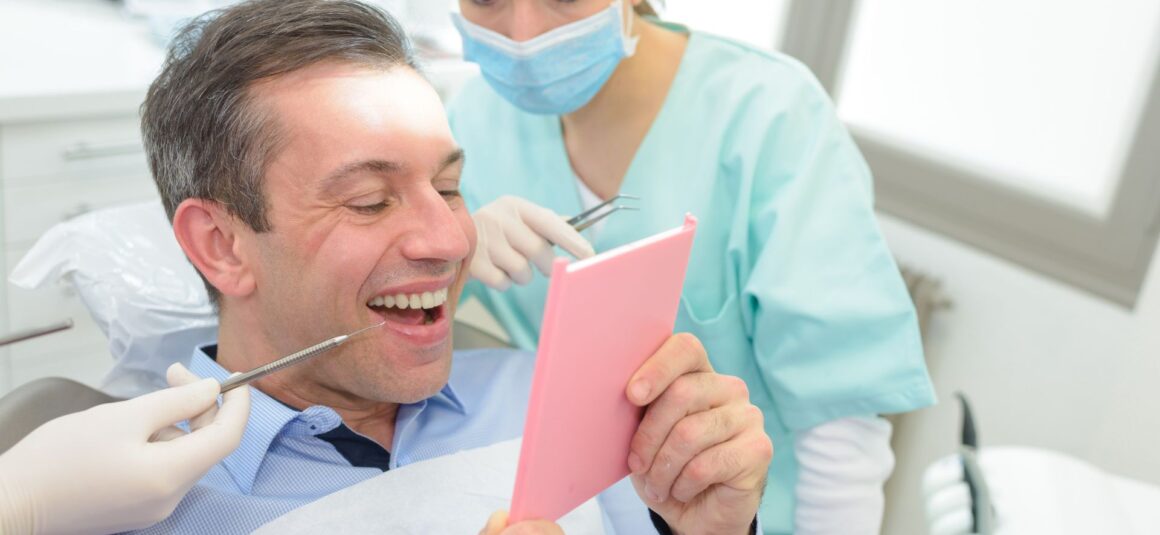 Patient being shown dental results - how long do dental bridge last - Midland Bay Dental.